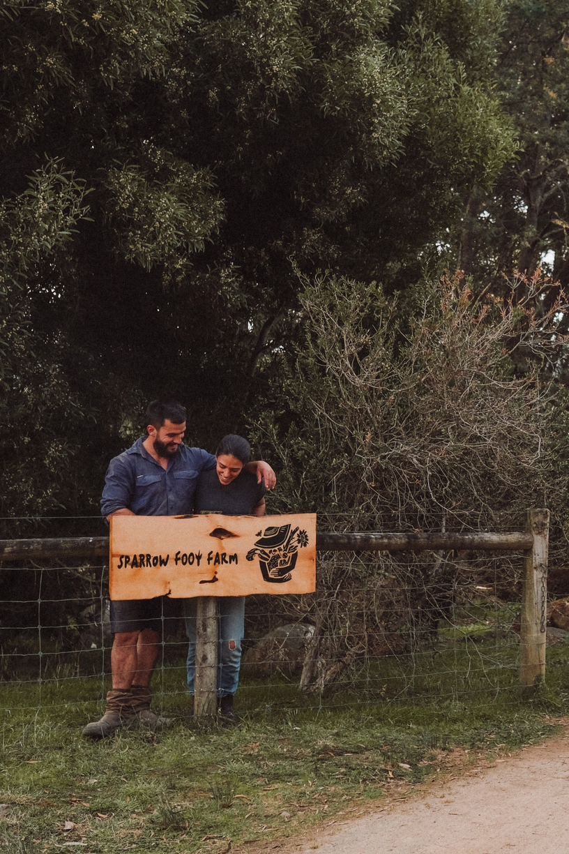 Inés and David with the Sparrow Foot Farm sign